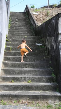 salvador, bahia / brazil - july 2, 2020: child is seen climbing stairs in residential condominium in the city of Salvador.