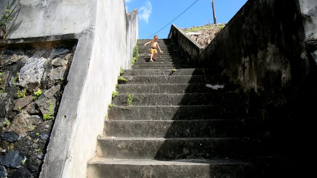 salvador, bahia / brazil - july 2, 2020: child is seen descending stairs in residential condominium in the city of Salvador....