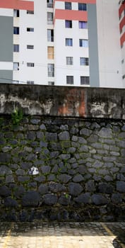 salvador, bahia / brazil - july 2, 2020: stone masonry wall seen in residential condominium in the city of Salvador.