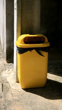 salvador, bahia / brazil - july 2, 2020: yellow trash can is seen in a condominium area in the city of Salvador..