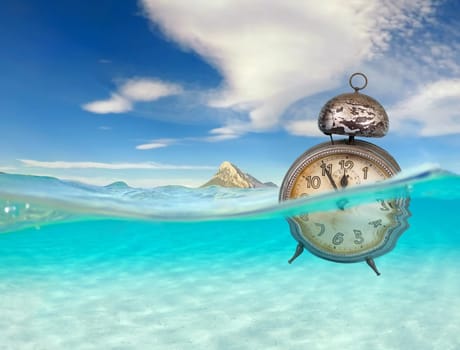 turquoise ocean with underwater view and clock, global warming of the oceans, time to change, concept for environmental protection