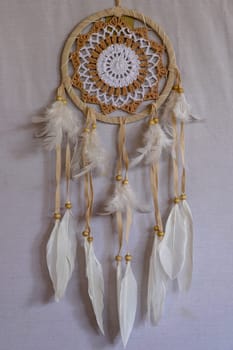 White crocheted dreamcatcher, an Indian amulet that protects the sleeper from evil spirits and diseases. Soft focus. Closeup.