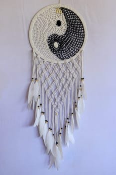 White and black dream catcher Yin Yang. Knitted Indian amulet.