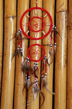 Red white blue Dreamcatcher on bamboo background.