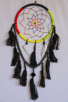 Beautiful multicolored handmade dreamcatcher with sea shells on white background.