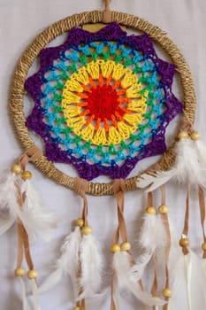 Beautiful multicolored handmade dreamcatcher on white background.