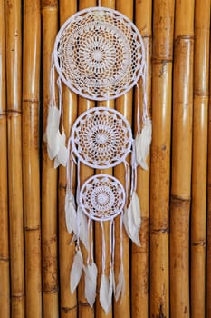 White crocheted dreamcatcher, an Indian amulet that protects the sleeper from evil spirits and diseases. Soft focus. Closeup.