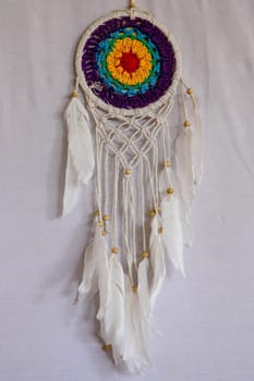 Beautiful multicolored handmade dreamcatcher on white background.