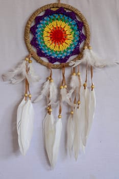 Beautiful multicolored handmade dreamcatcher on white background.