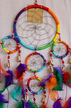 Beautiful multicolored handmade dreamcatcher on white background.