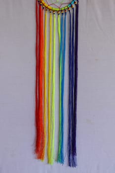 Beautiful multicolored handmade dreamcatcher on white background.