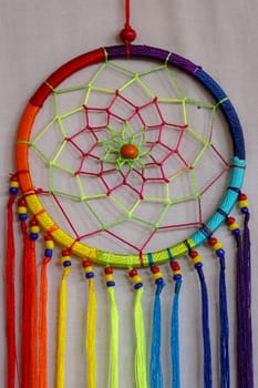 Beautiful multicolored handmade dreamcatcher on white background.
