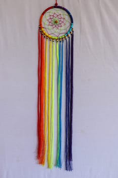 Beautiful multicolored handmade dreamcatcher on white background.