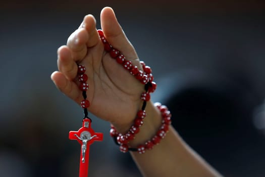 salvador, bahia / brazil - march 19, 2019: person holding religious rosary during mass at the Irma Dulce sanctuary in the city of Salvador.