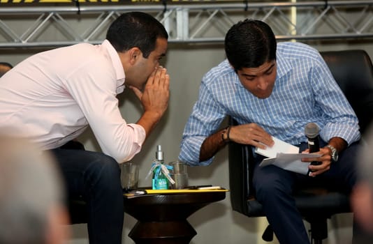 salvador, bahia / brazil - february 16, 2017: Bruno Reis, vice mayor of Salvador, talks with ACM Neto, mayor, during an event in the city of Salvador.