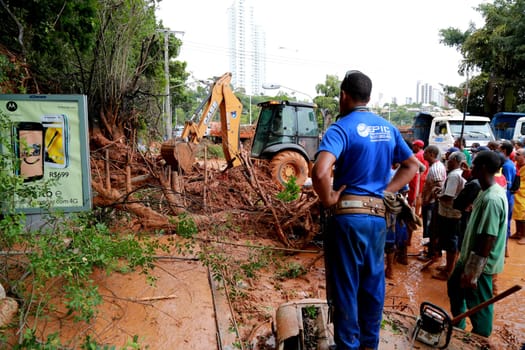 salvador, bahia / brazil - april 9, 2015: members of the fire department and volunteer people are seen during excavation of land that slid from a slope in the city of Salvador. the group seeks victims in the middle of the earth....