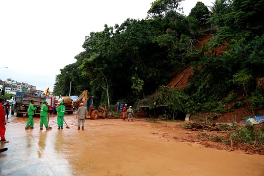 salvador, bahia / brazil - april 9, 2015: members of the fire department and volunteer people are seen during excavation of land that slid from a slope in the city of Salvador. the group seeks victims in the middle of the earth....
