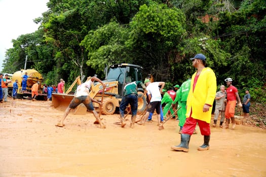 salvador, bahia / brazil - april 9, 2015: members of the fire department and volunteer people are seen during excavation of land that slid from a slope in the city of Salvador. the group seeks victims in the middle of the earth....