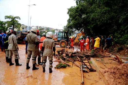 salvador, bahia / brazil - april 9, 2015: members of the fire department and volunteer people are seen during excavation of land that slid from a slope in the city of Salvador. the group seeks victims in the middle of the earth....