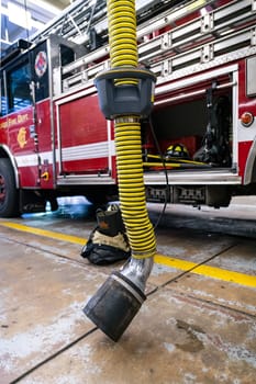CHICAGO, ILLINOIS, USA - OCTOBER 10, 2018: The fireman's clothes by the real squad fire truck in Chicago Fire Department at the quarters of Engine Co. 5. The legendary series 'Chicago Fire' reportage