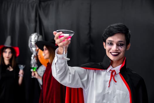 Portrait of asian young adult teenage man wear Halloween costume cloth with group of friends in Halloween party background. Halloween celebrate and international holiday concept.