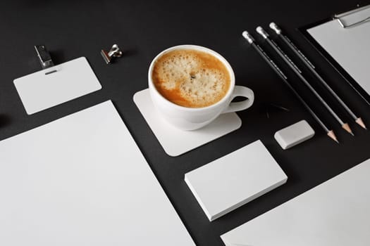 Branding mock up. Photo of blank corporate stationery set on black paper background.