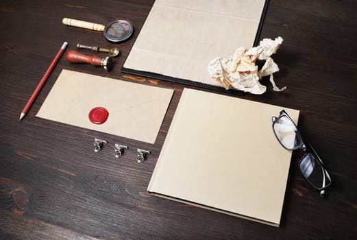 Photo of blank vintage stationery set on wooden background. Corporate identity template. Responsive design mockup.