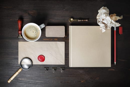 Photo of blank kraft stationery set on wooden background. Corporate identity mock up for placing your design. Flat lay.