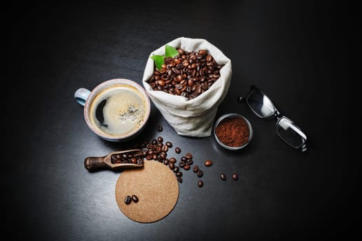 Delicious fresh coffee on black kitchen table background.