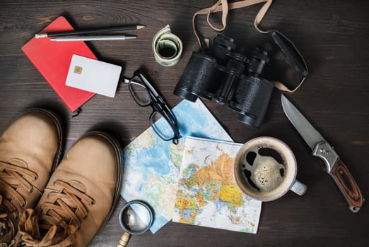Outfit of traveler on wooden background. Tourism concept. Travel accessories and items. Top view. Flat lay.
