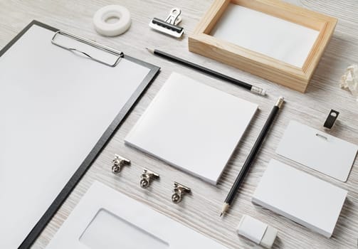 Blank corporate stationery on light wooden background. Template for branding identity.