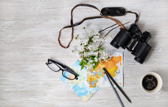 Objects for tourism and travel on light wooden background. Trip or vacation items. Top view. Flat lay.