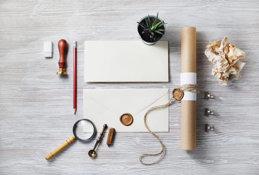 Blank vintage stationery set. Business brand template on light wood table background. Flat lay.