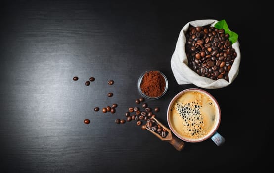 Brewing coffee background. Coffee cup, ground powder and coffee beans in canvas bag on black kitchen table background. Top view. Flat lay.