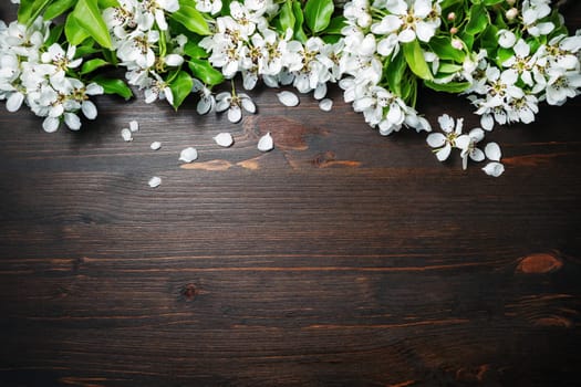 Wood table background with spring flowers. Copy space for your text. Flat lay.