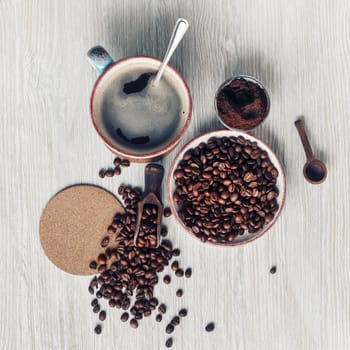 Making coffee still life. Coffee cup, roasted coffee beans, ground powder and beer coaster. Flat lay.
