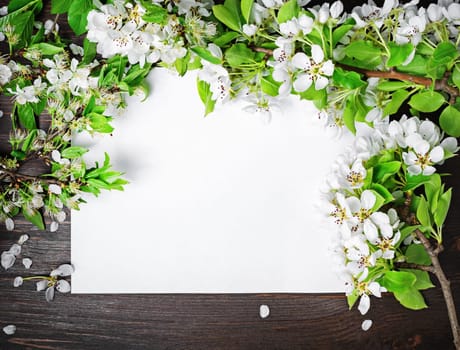 Mock up poster with spring flowers on wood table background. Flat lay.