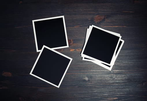 Blank photo frames. Square frames template on vintage wooden background. Flat lay.