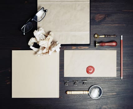 Blank branding identity set on wood table background. Retro stationery template. Top view. Flat lay.