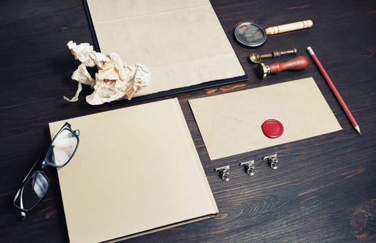 Photo of blank kraft stationery set on wooden background. Business brand template. Branding mock up.