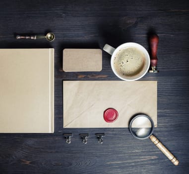 Blank vintage envelope and retro stationery on wood table background. Top view. Flat lay.