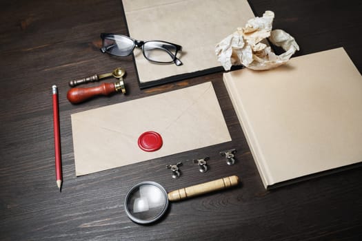 Kraft corporate identity template on wood table background. Photo of blank stationery set. Mockup for design presentations and portfolios.