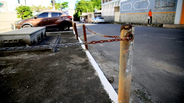 salvador, bahia / brazil - july 4, 2020: rusty chain is seen on the street in the neighborhood of Cabula in the city of Salvador...