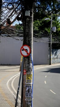 salvador, bahia / brazil - july 4, 2020: traffic signs indicate forbidden to turn left, seen on a pole connected to the electricity grid in the Cabula neighborhood, in the city of Salvador.....