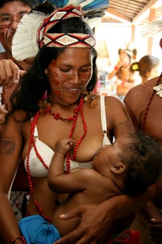 porto seguro, bahia / brazil - february 27, 2008: pataxo indian woman breastfeeds her son during a protest in search of improvements in the health system of her village in the city of Porto Seguro