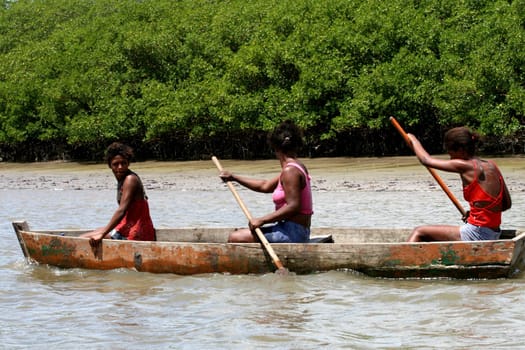 caravelas, bahia / brazil - march 25, 2008: women are seen in a rowing boat on the Cavelas River in southern Bahia..