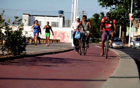 salvador, bahia / brazil - december 2, 2015: cyclist on a bike path on Avenida Beira Mar in the Ribeira neighborhood in the city of Salvador.