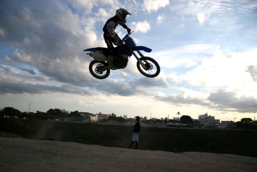 eunapolis, bahia / brazil - june 13, 2008: biker jumps with a motorcycle during motocross training in the city of Eunapolis.