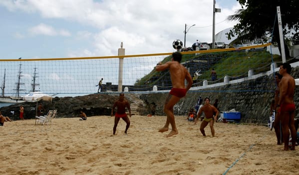 eunapolis, bahia / brazil - october 26, 2014: people are seen watching football on the beach at Porto da Barra in the city of Salvador.