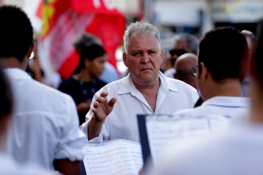 salvador, bahia / brazil - june 28, 2019: Fred Dantas, conductor is seen conducting an orchestra on the street in the city of Salvador.